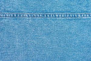 blå denim jeans med en söm textur bakgrund foto