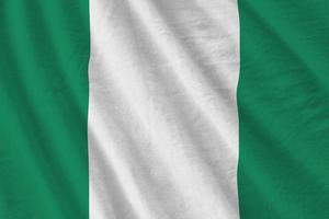 nigeria flagga med stor veck vinka stänga upp under de studio ljus inomhus. de officiell symboler och färger i baner foto