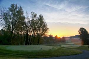 en solnedgång över en golf kurs foto