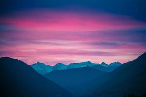 bergslandskap med färgglad rosa solnedgång foto