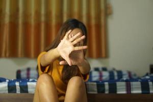 asiatisk kvinna använder sig av henne händer till skydda mot inkommande faror foto