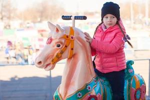 liten flicka på en karusell foto