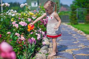 liten flicka med skön blommor foto