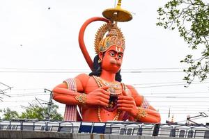 ny delhi, Indien - juni 21, 2022 - stor staty av herre hanuman nära de delhi metro bro belägen nära karol bagh, delhi, Indien, herre hanuman stor staty rörande himmel foto
