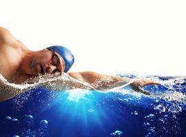 pojke simmar i en blå djup vatten . vit Plats för din text foto