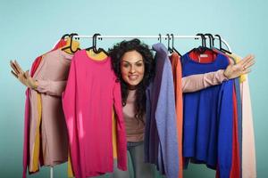 kvinna väljer de kläder till köpa i en Lagra. begrepp av handla och shopaholic. foto
