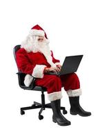 santa claus Arbetar med hans bärbar dator för jul foto