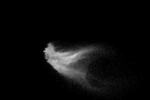 vitt pulver explosion moln mot svart bakgrund. vita dammpartiklar stänk. foto
