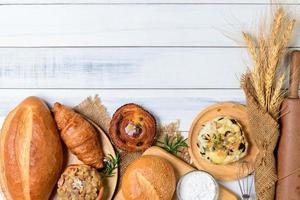 hemlagad bröd eller bulle på trä bakgrund, croissant med surdeg och dansk bakverk, foto