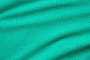 grön sporter Kläder tyg fotboll skjorta jersey textur bakgrund foto
