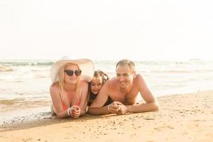 Lycklig familj på hav strand på tillflykt foto