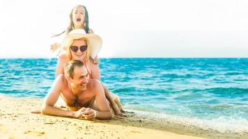 Lycklig familj på hav strand på tillflykt foto