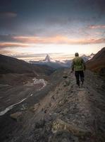 zermatt berg landskap, en vandrare gående på en smal väg foto