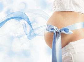 blå rosett på gravid kvinna foto