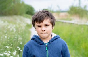 porträtt leende unge njut av spelar utanför i de morgon, glad ung pojke spelar utomhus- i de trädgård, barn avkopplande på solig dag vår eller sommar i de parkera, lära sig och spela utomhus aktivitet foto