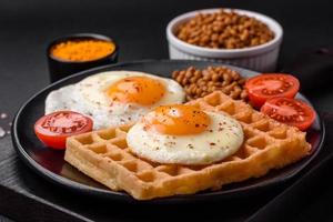 utsökt hjärtlig frukost bestående av en friterad ägg, belgisk våffla foto