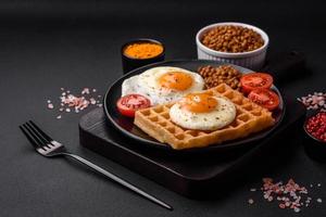 utsökt hjärtlig frukost bestående av en friterad ägg, belgisk våffla foto