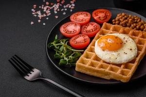 utsökt hjärtlig frukost bestående av en friterad ägg, belgisk våffla foto