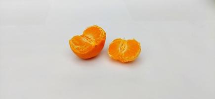 skalad av citrus- sinensis, kallad jeruk bebis santang med löv isolerat på vit bakgrund. lokal- färsk frukt från indonesien foto