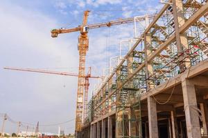 industriella konstruktionskranar och byggnad i en vacker bakgrund för blå himmel foto