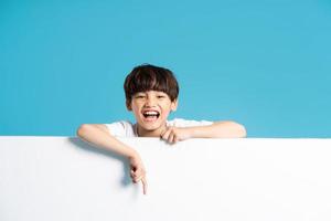 asiatisk pojke porträtt på blå bakgrund foto