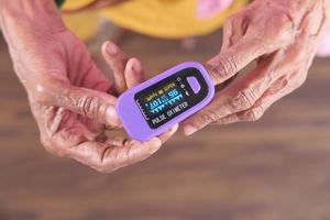 äldre kvinnas hand med pulsoximeter