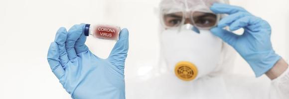 tar beslut. fokuserade Foto på manlig händer den där innehav glas paket med antivirus vaccin