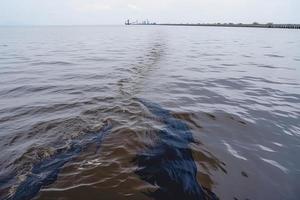 olja läcka från fartyg , olja spill förorening förorenad vatten yta. vatten förorening som en resultat av mänsklig aktiviteter foto