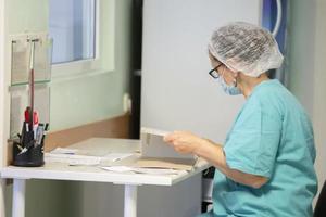 en läkare i en sjukhus eller klinik Arbetar med papper. foto