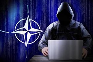 anonym huvor hacker och flagga av Nato, binär koda - cyber ge sig på begrepp foto