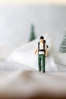 miniatyr- människor backpacker resa i vinter- tid foto