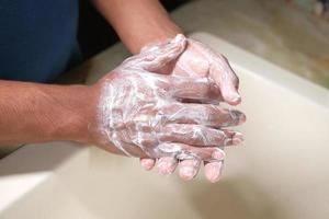 ung man tvättar händerna foto