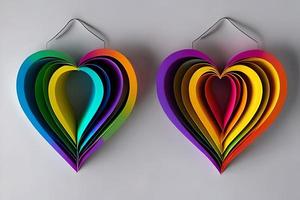 två hängande regnbåge färgad papper skära ut i de kärlek hjärta form. papper konst regnbåge hjärta bakgrund med 3d effekt, hjärta form i vibrerande färger, vektor illustration. foto