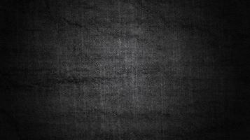 svart vägg lutning bakgrund med mörk och grov textur. foto