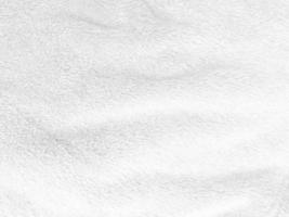 vit ren ull textur bakgrund. lätt naturlig fårull. vit sömlös bomull. textur av fluffig päls för designers. närbild fragment vit ull matta. foto