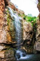 vatten cascading ner en sten ansikte foto