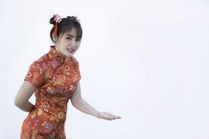 porträtt vacker asiatisk kvinna i cheongsam klänning, thailändska människor, gott kinesiskt nyårs koncept, glad asiatisk dam i traditionell kinesisk klänning foto