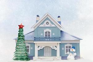 jul kort. hus jul träd snögubbe på en blå snöig bakgrund. foto