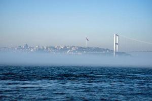 de dimma över de bosphorus sund, de bakgrund på de bro, och höghus byggnader. foto