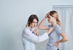 kvinna på de läkares utnämning medicinsk klänning stetoskop hälsa foto