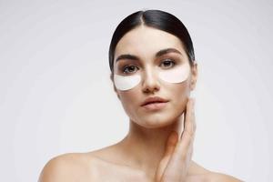 kvinna innehav ansikte föryngring rena hud kosmetika närbild foto