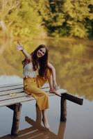 en hippie kvinna utomhus förbi de sjö har roligt i de falla foto