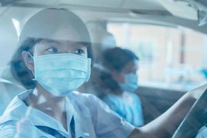 barn i bil bär ansikte mask skydda av luft förorening och virus epidemi av covid 1 foto