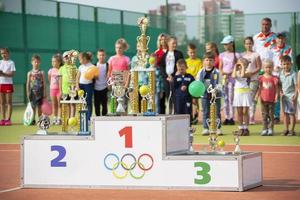 belarus, de stad av gomil, september 08, 2018. öppen tennis domstolar. sporter piedestal med koppar på en bakgrund av suddig barn idrottare. foto