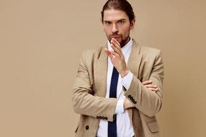 modern man emotionell man i kostym gest med händer beige bakgrund foto