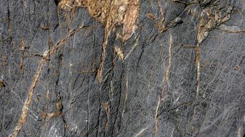 mörk bakgrund textur av naturlig sten foto