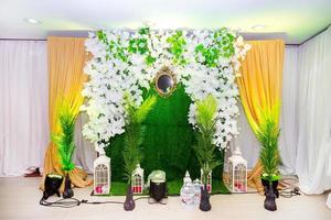grön artificiell gräs baserad bröllop skede med artificiell färgrik papper blomma dekoration. foto