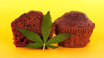 brownie kaka och grönt blad marijuana på en gul bakgrund
