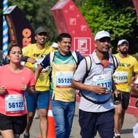 ny delhi, Indien - Mars 16 2023 - vedanta delhi halv maraton lopp efter covid i som maraton deltagarna handla om till korsa de Avsluta linje, delhi halv maraton 2022 foto