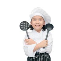 Lycklig asiatisk flicka kock innehav matlagning redskap foto